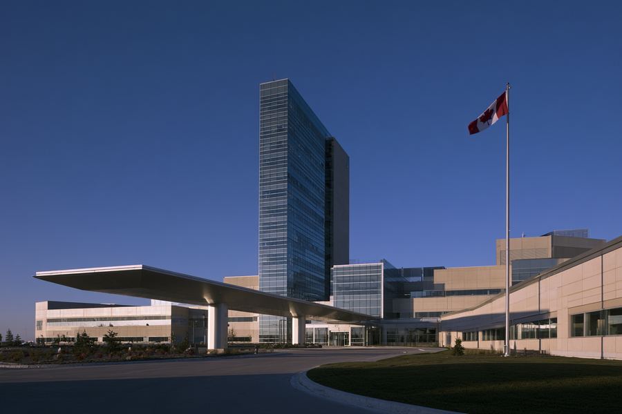 Exterior of a modern regional hospital with a glass tower entrance
